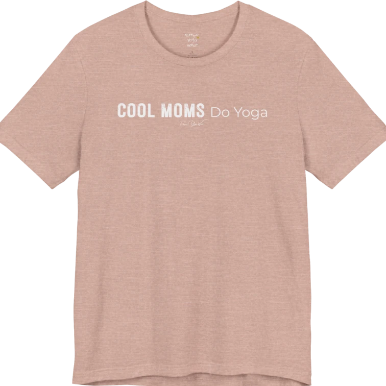 A short sleeved tee called the Moms T-Shirt, flat lay and a soft cotton shirt. Simply says, Cool Moms Do Yoga. Design highlights bold distressed block lettering for Cool Moms beside lighter thin lettering for Do Yoga, with a small script signature underneath. Color is Heather Prism Peach.