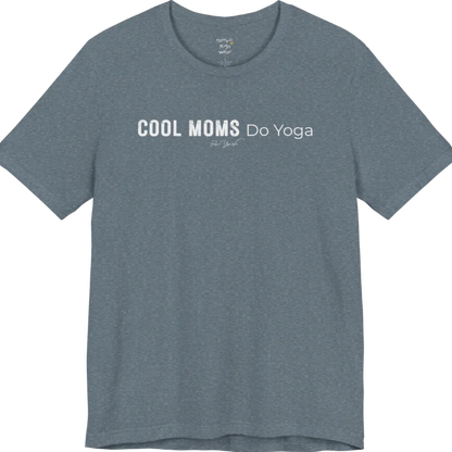 A short sleeved tee called the Moms T-Shirt, flat lay and a soft cotton shirt. Simply says, Cool Moms Do Yoga. Design highlights bold distressed block lettering for Cool Moms beside lighter thin lettering for Do Yoga, with a small script signature underneath. Color is Heather Slate.