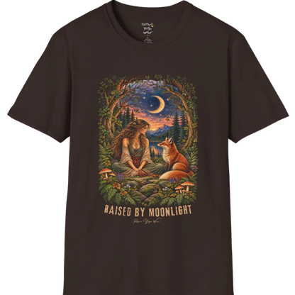 A short sleeved tee called the Moonlight T-Shirt, flat lay and a Gildan 64000 shirt. Simply says, Raised By Moonlight. Design highlights a woman sitting cross-legged in a moonlit forest clearing with a fox beside her, surrounded by mushrooms and ferns, in a full-color painted illustration style. Color is Dark Chocolate.