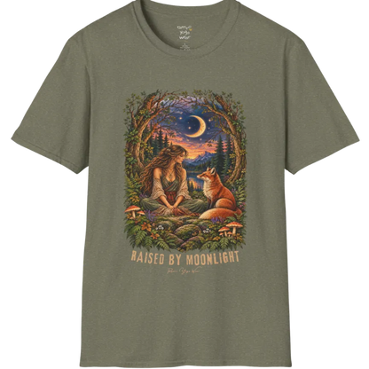 A short sleeved tee called the Moonlight T-Shirt, flat lay and a Gildan 64000 shirt. Simply says, Raised By Moonlight. Design highlights a woman sitting cross-legged in a moonlit forest clearing with a fox beside her, surrounded by mushrooms and ferns, in a full-color painted illustration style. Color is Heather Military Green.