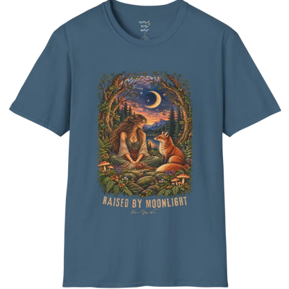 A short sleeved tee called the Moonlight T-Shirt, flat lay and a Gildan 64000 shirt. Simply says, Raised By Moonlight. Design highlights a woman sitting cross-legged in a moonlit forest clearing with a fox beside her, surrounded by mushrooms and ferns, in a full-color painted illustration style. Color is Indigo Blue.