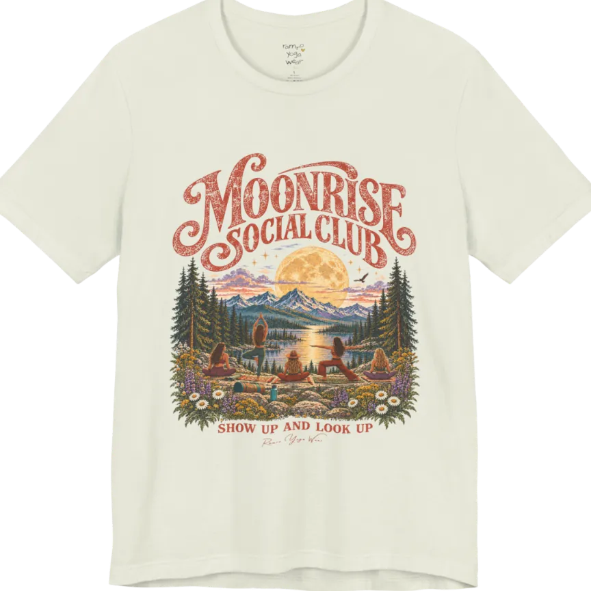 A short sleeved tee called the Moonrise T-Shirt, flat lay and a Bella+Canvas 3001. Simply says, Moonrise Social Club. Show Up And Look Up. Design highlights five women seen from behind practicing yoga on a rocky lakeside shelf, one in tree pose, one in warrior pose and three seated, beneath a glowing full moon rising over snow-capped mountains, framed by pine trees and wildflowers. Color is Citron.