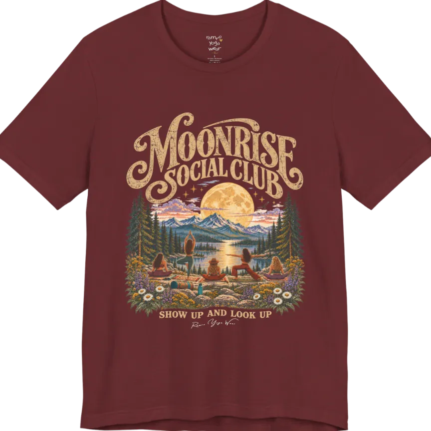 A short sleeved tee called the Moonrise T-Shirt, flat lay and a Bella+Canvas 3001. Simply says, Moonrise Social Club. Show Up And Look Up. Design highlights five women seen from behind practicing yoga on a rocky lakeside shelf, one in tree pose, one in warrior pose and three seated, beneath a glowing full moon rising over snow-capped mountains, framed by pine trees and wildflowers. Color is Heather Cardinal.