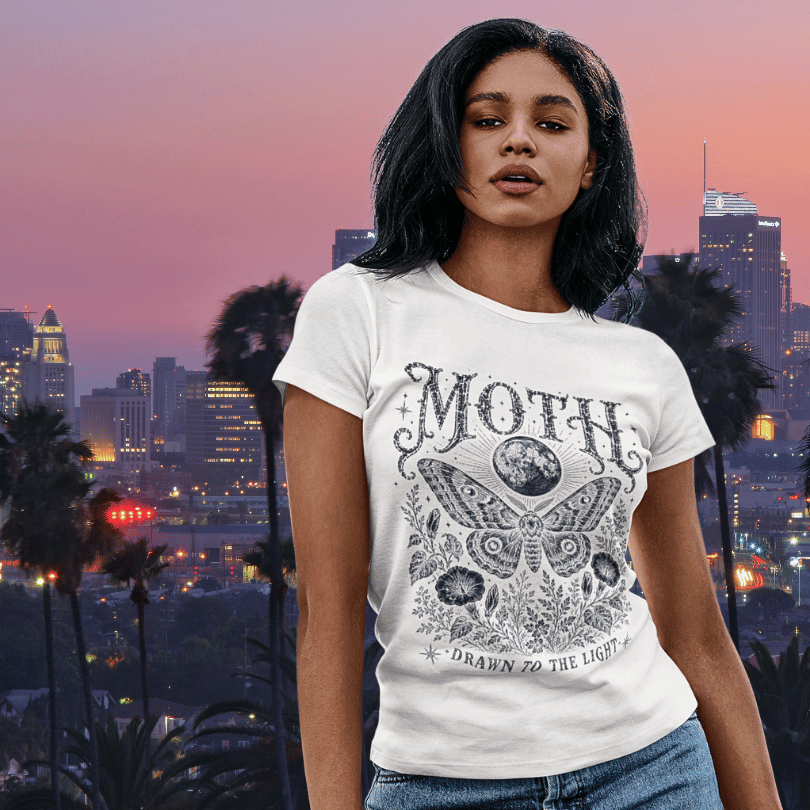 Ramro Yoga Wear Moth tee — lifestyle shot, city sunset, moth moon botanical vintage engraving