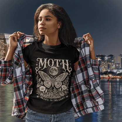 Ramro Yoga Wear Moth tee in Black — lifestyle shot, waterfront night, moth moon botanical vintage engraving