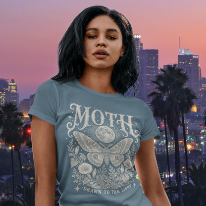 Ramro Yoga Wear Moth tee — lifestyle shot, city sunset, moth moon botanical vintage engraving