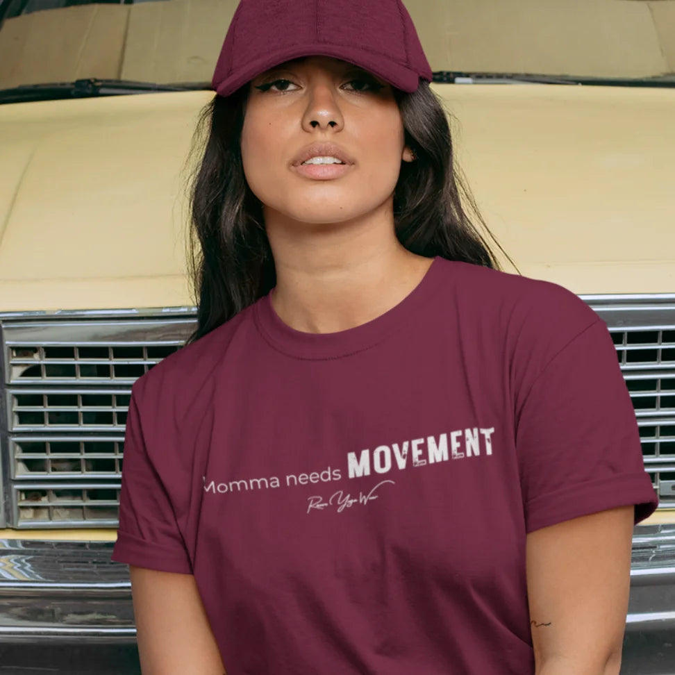 Person wearing the Movement T-Shirt in Heather Cardinal, wearing a cap and standing outdoors near a vintage car — Funny Yoga Shirts collection by Ramro Yoga Wear.