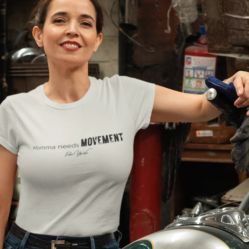Person wearing the Movement T-Shirt in Heather Prism Natural, standing indoors in a garage setting — Funny Yoga Shirts collection by Ramro Yoga Wear.