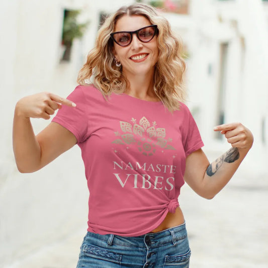 Namaste Vibes is a lifestyle and our model is wearing the Coral Silk Namaste Vibes T-Shirt outdoors with playful vintage typography and relaxed mindful energy.
