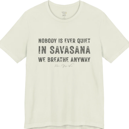 A short sleeved tee called the Nobody T-Shirt, flat lay and a soft cotton shirt. Simply says, Nobody is ever quiet in savasana. We breathe anyway. Design highlights three lines of bold condensed cream lettering with a small handwritten signature beneath. Color is Citron.