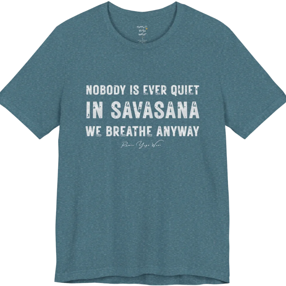 A short sleeved tee called the Nobody T-Shirt, flat lay and a soft cotton shirt. Simply says, Nobody is ever quiet in savasana. We breathe anyway. Design highlights three lines of bold condensed cream lettering with a small handwritten signature beneath. Color is Heather Deep Teal.