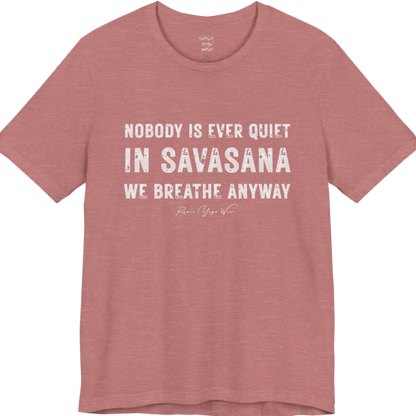 A short sleeved tee called the Nobody T-Shirt, flat lay and a soft cotton shirt. Simply says, Nobody is ever quiet in savasana. We breathe anyway. Design highlights three lines of bold condensed cream lettering with a small handwritten signature beneath. Color is Heather Mauve.