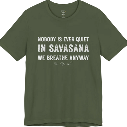 A short sleeved tee called the Nobody T-Shirt, flat lay and a soft cotton shirt. Simply says, Nobody is ever quiet in savasana. We breathe anyway. Design highlights three lines of bold condensed cream lettering with a small handwritten signature beneath. Color is Military Green.
