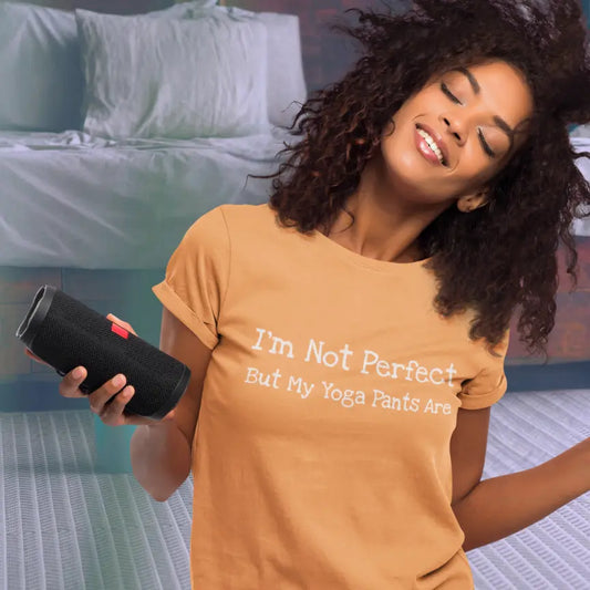 Not Perfect T-Shirt styled in a cozy lifestyle scene featuring the Heather Orange colorway. Funny yoga lifestyle tee with relaxed feminine styling and soft everyday comfort.