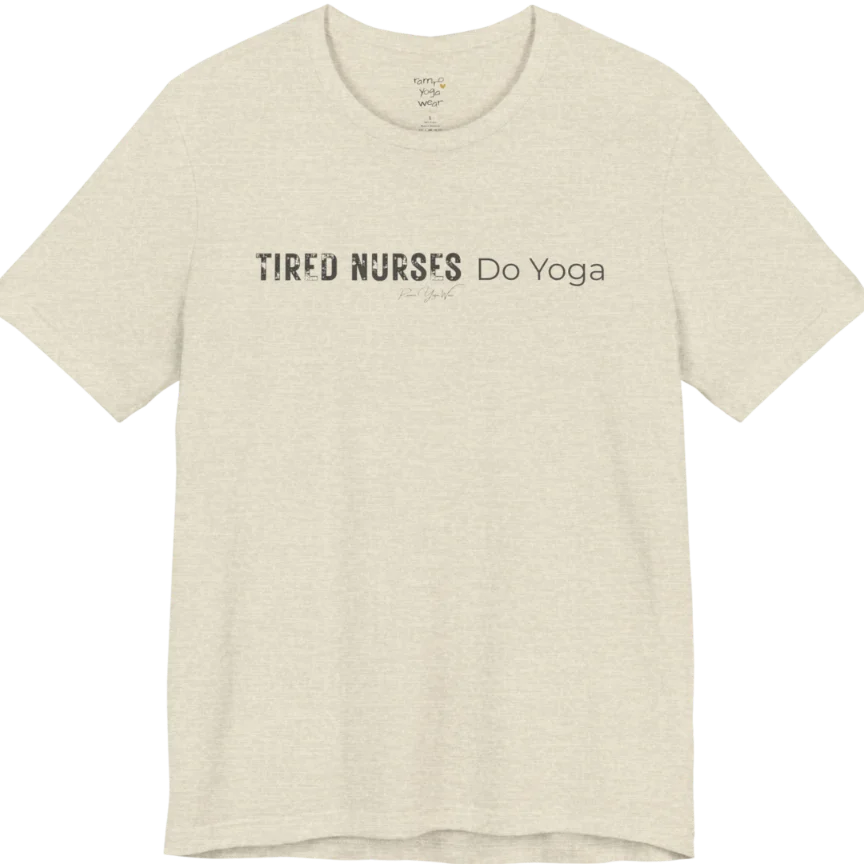 A short sleeved tee called the Nurses T-Shirt, flat lay and a soft cotton blend shirt. Simply says, Tired Nurses Do Yoga. Design highlights bold distressed block lettering for TIRED NURSES beside thin lettering for Do Yoga, with a small script signature underneath. Color is Heather Prism Natural.