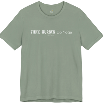 A short sleeved tee called the Nurses T-Shirt, flat lay and a soft cotton blend shirt. Simply says, Tired Nurses Do Yoga. Design highlights bold distressed block lettering for TIRED NURSES beside thin lettering for Do Yoga, with a small script signature underneath. Color is Sage.