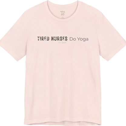 A short sleeved tee called the Nurses T-Shirt, flat lay and a soft cotton blend shirt. Simply says, Tired Nurses Do Yoga. Design highlights bold distressed block lettering for TIRED NURSES beside thin lettering for Do Yoga, with a small script signature underneath. Color is Soft Pink.