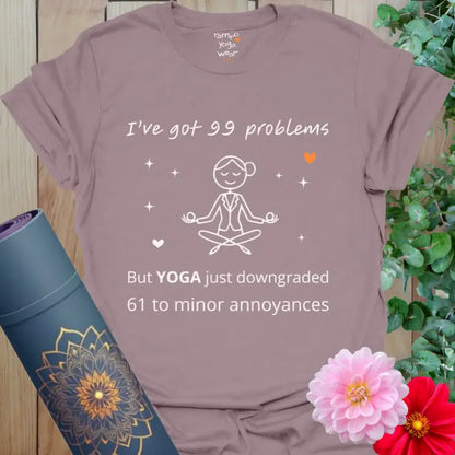 Paragon 99 Problems T-Shirt featuring humorous yoga quote “I’ve got 99 problems but YOGA just downgraded 61 to minor annoyances.”
Minimalist meditating figure and small orange heart detail.
