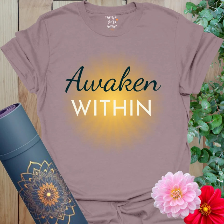 Paragon Awaken T-Shirt with soft golden burst and “Awaken Within” design. Soulful yoga tee with grounded presence and radiant calm.