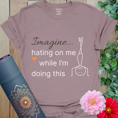 Paragon Imagine T-Shirt in muted mauve with yoga humor quote “Imagine hating on me while I’m doing this.” Minimalist white design, soft orange heart, serene Ramro vibe.