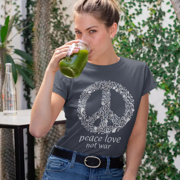 Woman wearing Peace Heather Navy T-Shirt outdoors among trees, drinking from a bottle — The Vault collection by Ramro Yoga Wear