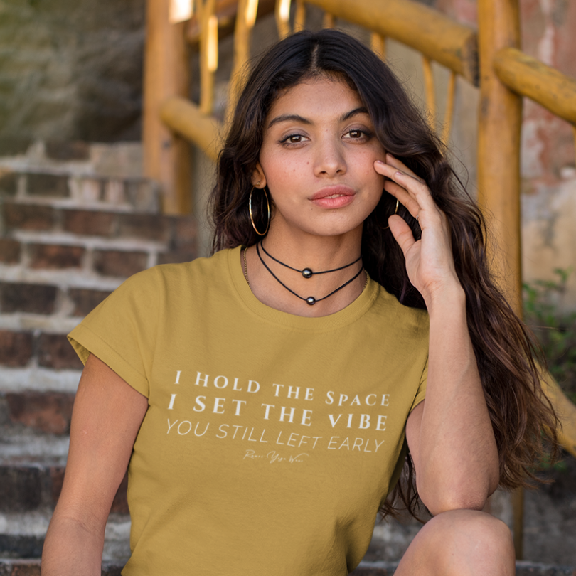 Woman wearing Playlist Heather Mustard yoga teacher gift tee sitting on outdoor steps — Yoga Teacher Gifts collection by Ramro Yoga Wear