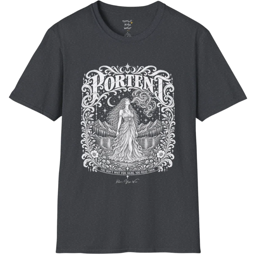 A short sleeved tee called the Portent T-Shirt, flat lay and a soft cotton shirt. Simply says, You don't wait for signs. You read them. Design highlights an ornate engraved frame of florals and filigree around a long-haired figure in a flowing gown standing before mountains and still water, with a crescent moon, stars and swirling smoke above and Portent in decorative lettering across the top. Color is Dark Heather Grey.