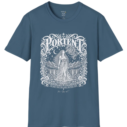 A short sleeved tee called the Portent T-Shirt, flat lay and a soft cotton shirt. Simply says, You don't wait for signs. You read them. Design highlights an ornate engraved frame of florals and filigree around a long-haired figure in a flowing gown standing before mountains and still water, with a crescent moon, stars and swirling smoke above and Portent in decorative lettering across the top. Color is Indigo Blue.