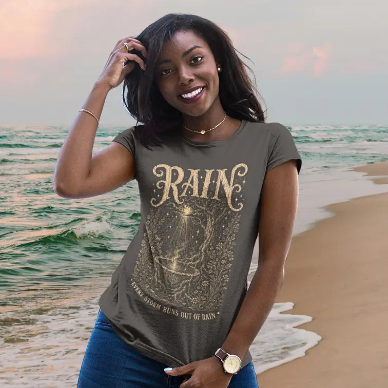 Person wearing Rain tee in Dark Chocolate, a sacred yoga shirt at the beach at sunset — Sacred Thread collection by Ramro Yoga Wear