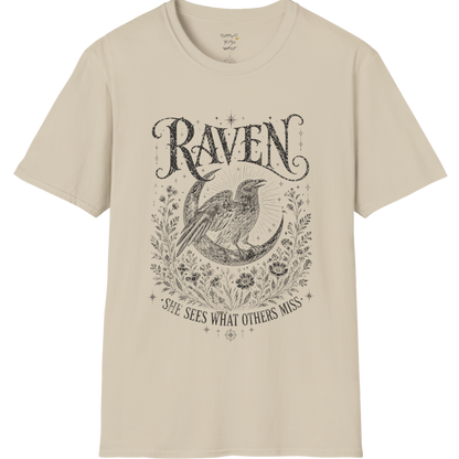 Sand Raven T-Shirt featuring spiritual raven artwork with botanical detailing, moon symbolism, and antique-inspired engraving textures