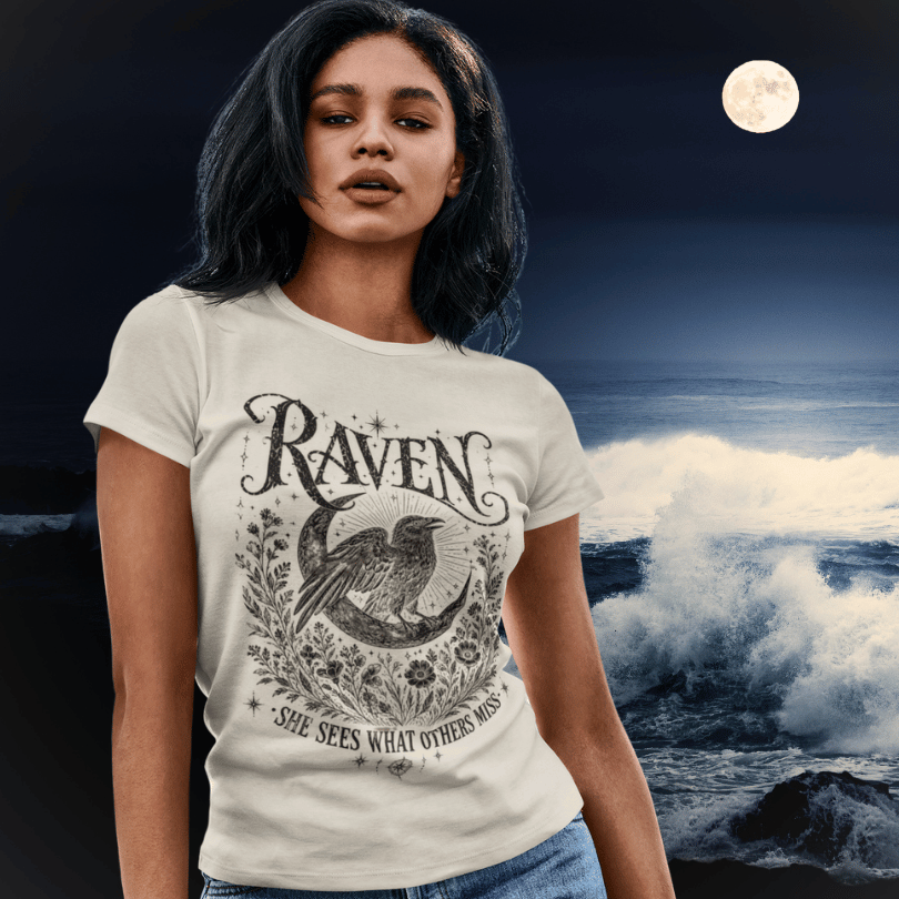 White Raven T-Shirt lifestyle image featuring mystical raven artwork styled beneath a glowing moonlit evening sky.