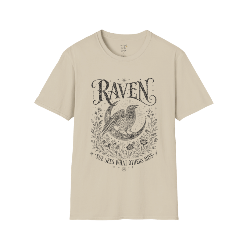 Sand Raven T-Shirt featuring spiritual raven artwork with botanical detailing, moon symbolism, and antique-inspired engraving textures.