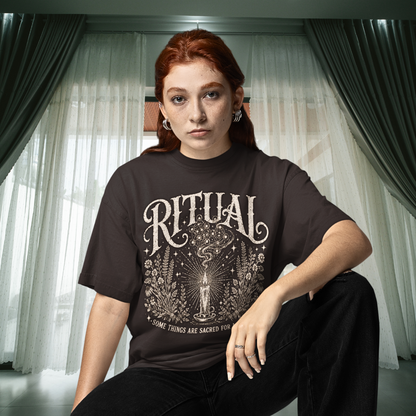 Person wearing the Ritual T-Shirt in Dark Chocolate, a sacred yoga shirt at home by a curtained window in the evening — Wild Devotion collection by Ramro Yoga Wear