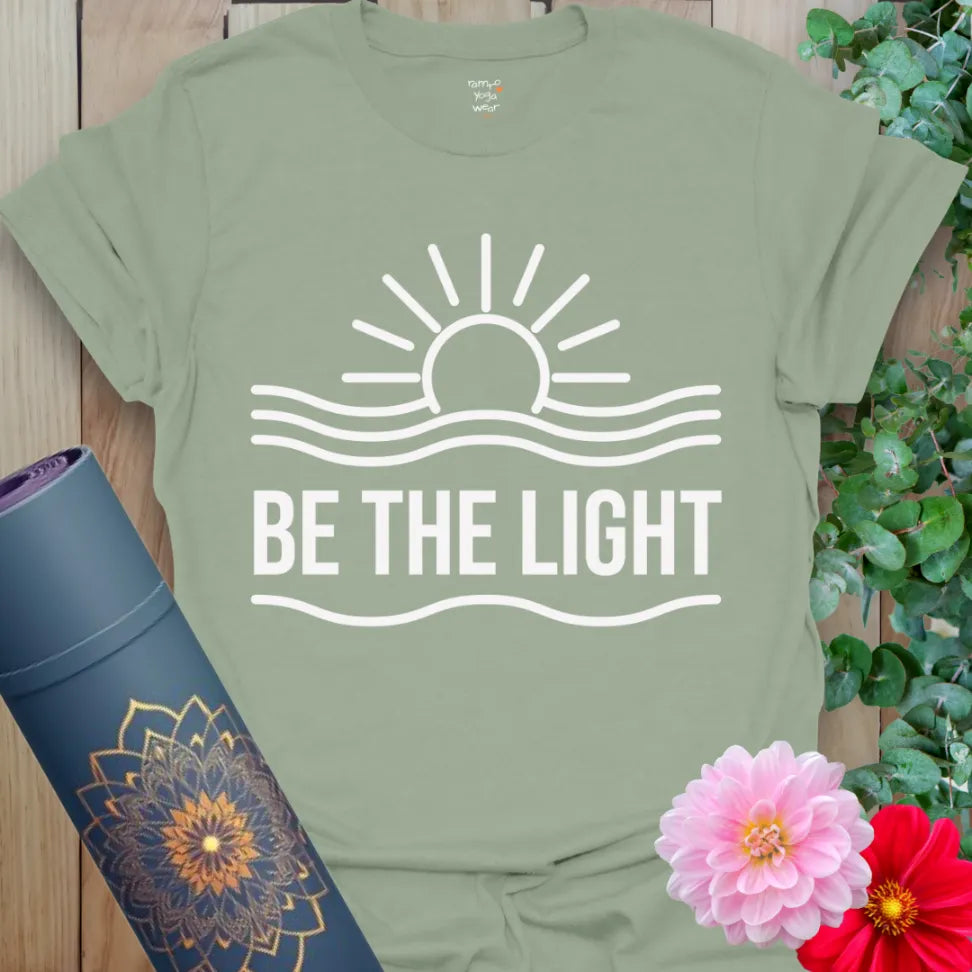 Calm sage green be the light t-shirt featuring mindful sunrise or sunset artwork symbolizing grounded soulful living.