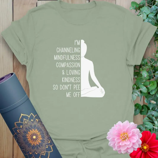 Sage green yoga shirt with “channeling mindfulness” quote and seated yogi silhouette