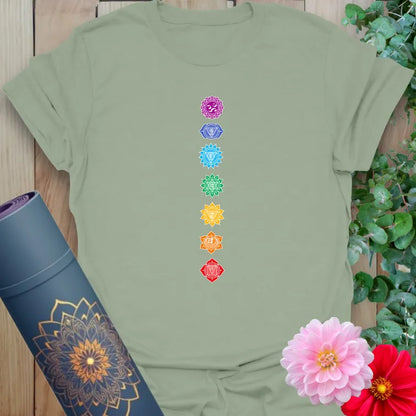 Calm sage green yoga t-shirt showcasing seven chakra symbols for balance and peaceful movement.