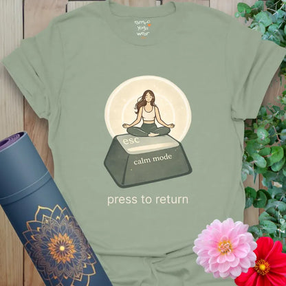 Sage Esc T-Shirt featuring a peaceful meditation illustration on an escape key. Soft yoga lifestyle graphic shirt.
