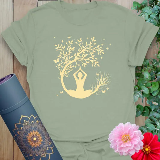 Calm sage green yoga t-shirt featuring serene yogi under crescent moon and blossoming tree for mindful movement.