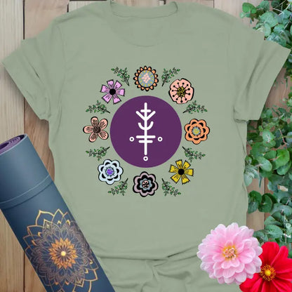 Calm sage green yoga t-shirt featuring vibrant floral mandala and spiritual symbol celebrating conscious growth and lucky alignment.