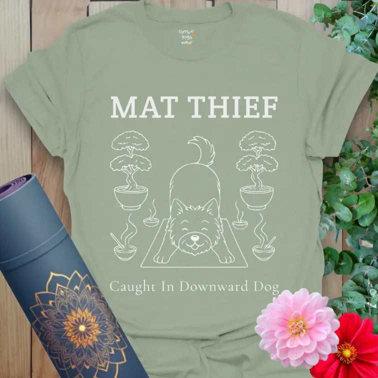 Sage Mat Thief T-Shirt featuring a minimalist dog in Downward Dog pose; calming color with fun yoga humor.