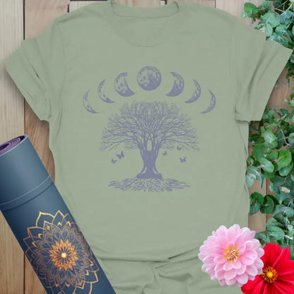 Calm sage green yoga t-shirt featuring rooted tree of life and moon phase design inspiring grounded spiritual presence and conscious movement.