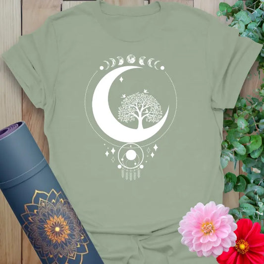 Calm sage green yoga t-shirt featuring sacred crescent moon, tree, and lunar cycle design inspiring grounded soulful presence.