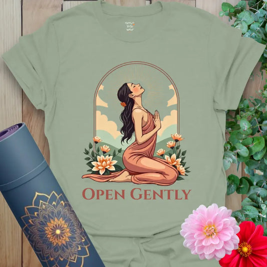 Calm sage green yoga t-shirt featuring soulful heart-opening figure and vibrant floral surroundings for peaceful, heart-led growth.