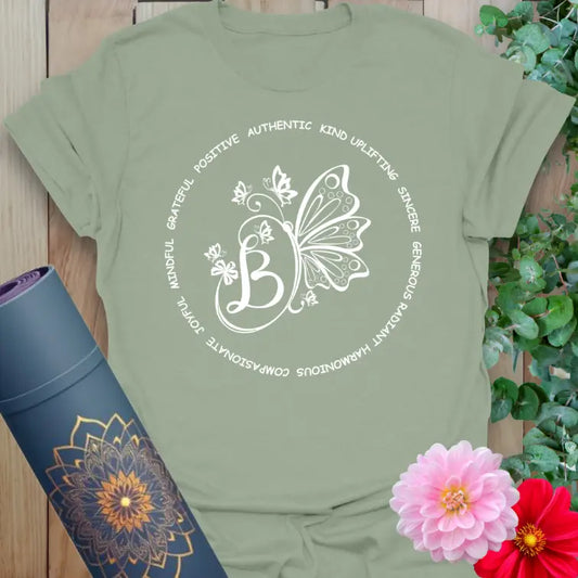 Calm sage green yoga t-shirt featuring inspirational affirmation circle and butterfly art for mindful, heart-centered lifestyles.