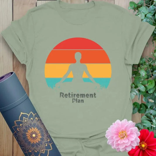 Calm sage green yoga t-shirt featuring meditating figure against sunset backdrop symbolizing soulful retirement dreams and mindful goals.