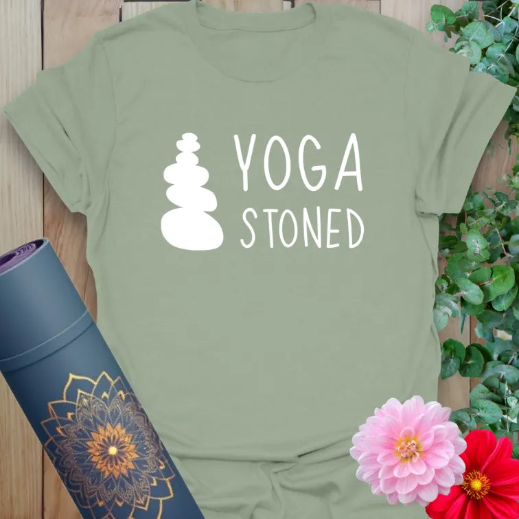 Sage green yoga t-shirt featuring clean stone illustration and “YOGA STONED” message, ideal for soulful chill-outs.