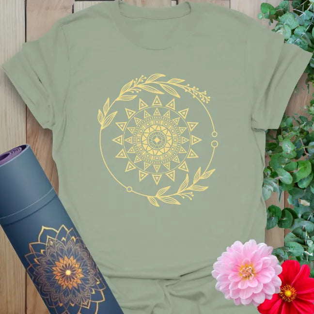 Sage green yoga t-shirt featuring golden solar mandala and botanical orbit for balance, light, and soulful movement