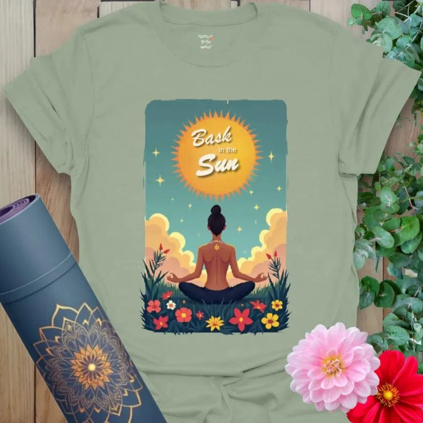 Sage green yoga t-shirt with morning meditation scene, rising sun, and nature-inspired illustration for grounded conscious style.