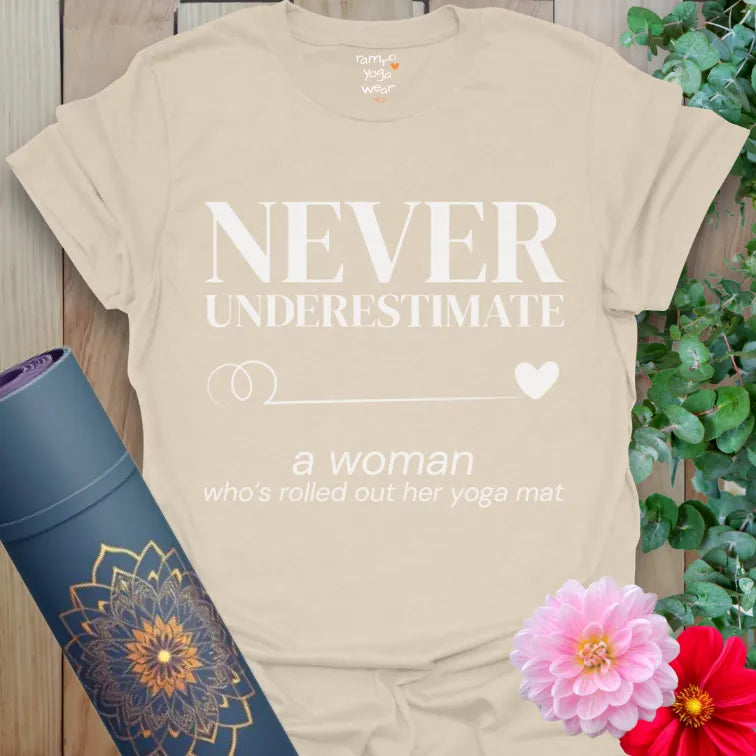 Sand Never Underestimate T-Shirt with bold serif quote and soft italic script. Yoga empowerment tee with minimalist swirl and heart.
