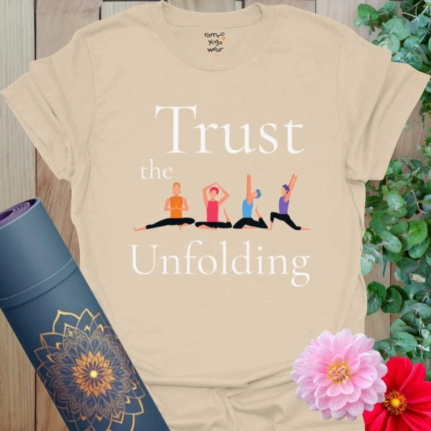 Sand Unfolding T-Shirt with illustrated yoga poses and a reminder to “Trust the Unfolding.” A wearable whisper of surrender and flow.